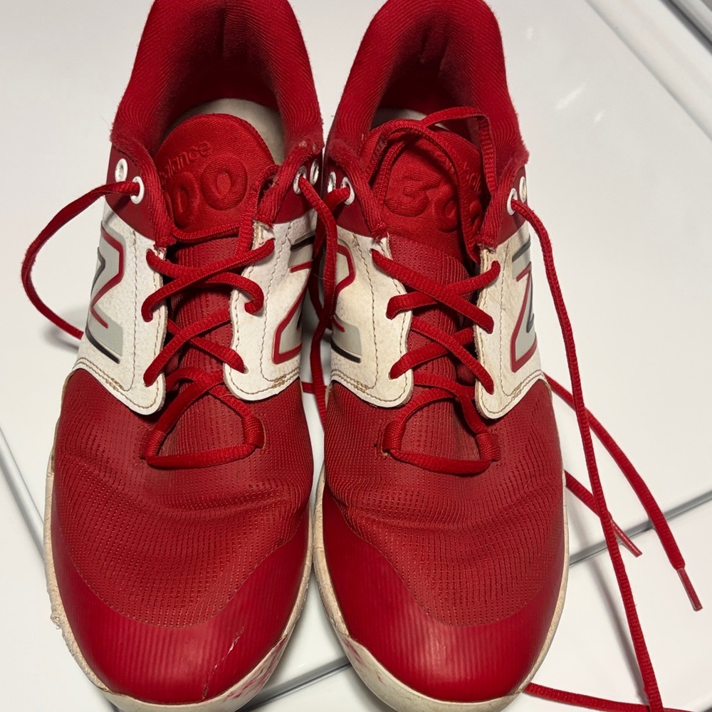 Red and White New Balance metal baseball cleats